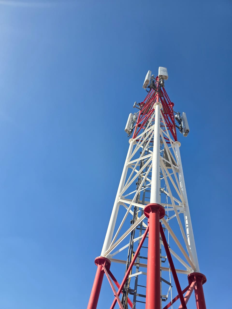 Aviation-marked tower against an open sky